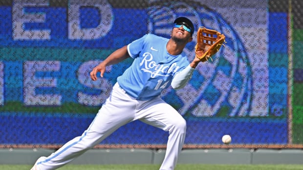 Jun 25, 2022; Kansas City, Missouri, USA; Kansas City Royals right fielder Edward Olivares (14) misplays a fly ball during the fourth inning against the Oakland Athletics at Kauffman Stadium. Mandatory Credit: Peter Aiken-USA TODAY Sports